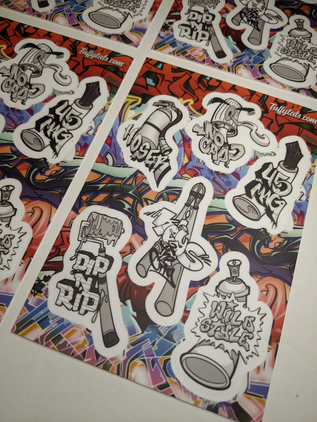 A set of six graffiti-themed stickers by Horus, featuring stylized illustrations of spray cans, a paint roller, and a fire extinguisher with urban slang tags like "No Cap" and "Wild Style."