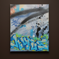 Graffiti-style artwork on a canvas with abstract design and text.