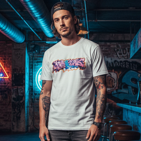 Man wearing a white t-shirt with colorful graphics in an urban setting with graffiti and neon lights.