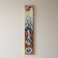 A tall skinny graffiti canvas featuring fudo myoo sword and stylized black and white lettering
