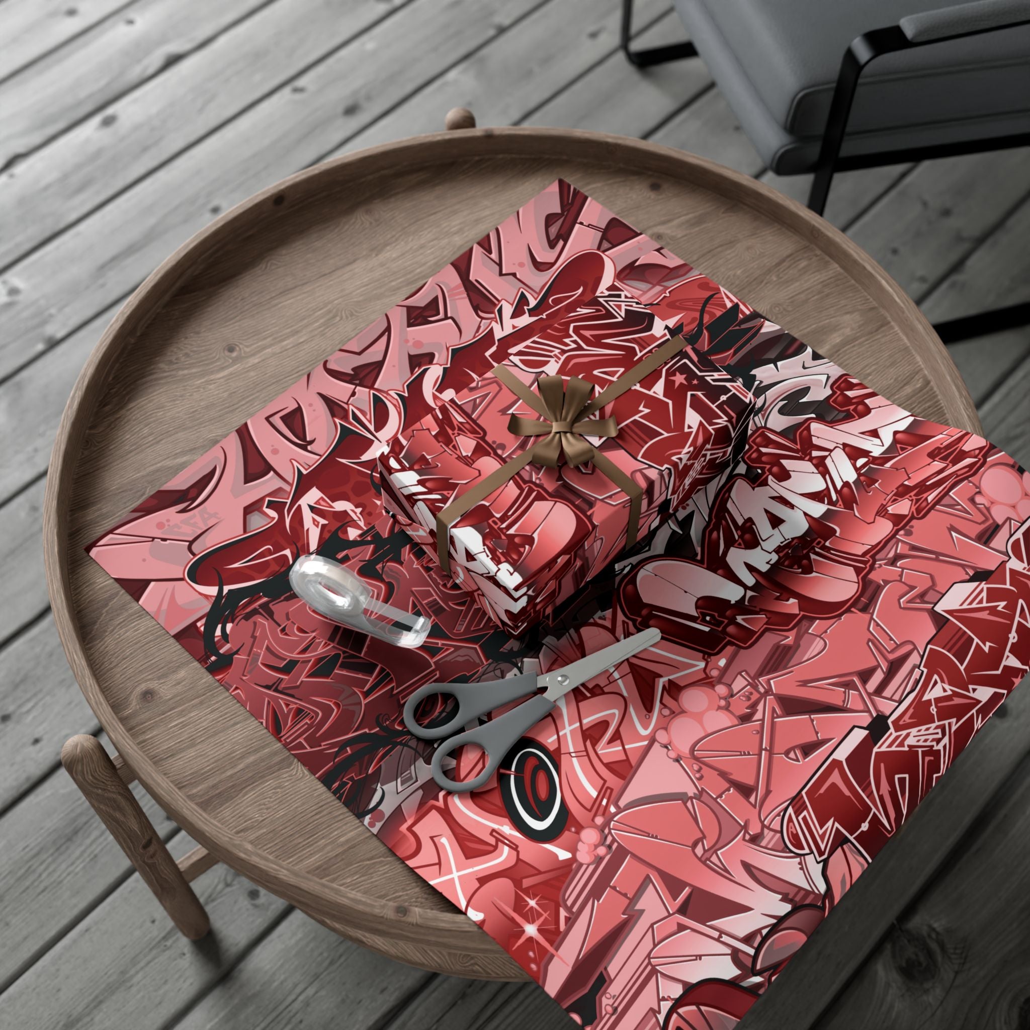 Red and black patterned paper with scissors on a wooden tray