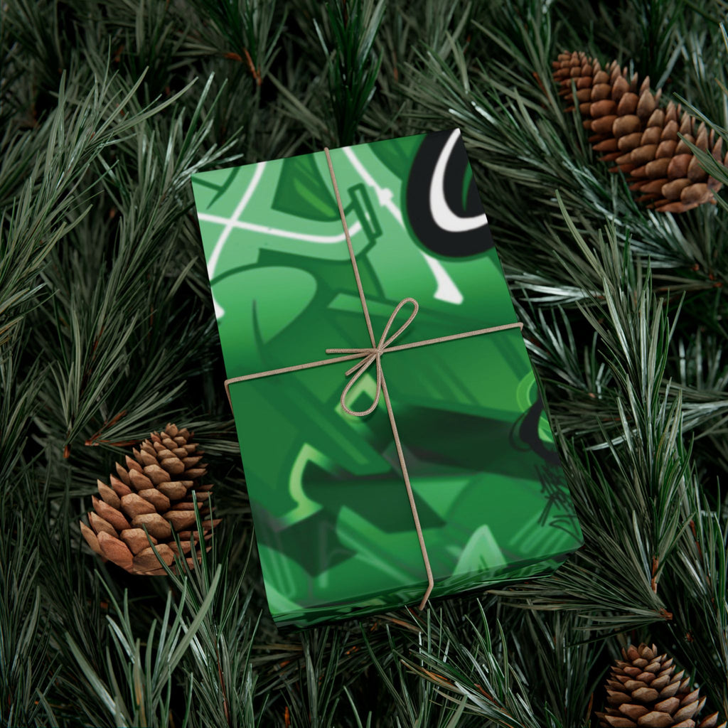 Green gift box with white patterns on a bed of pine needles and pine cones
