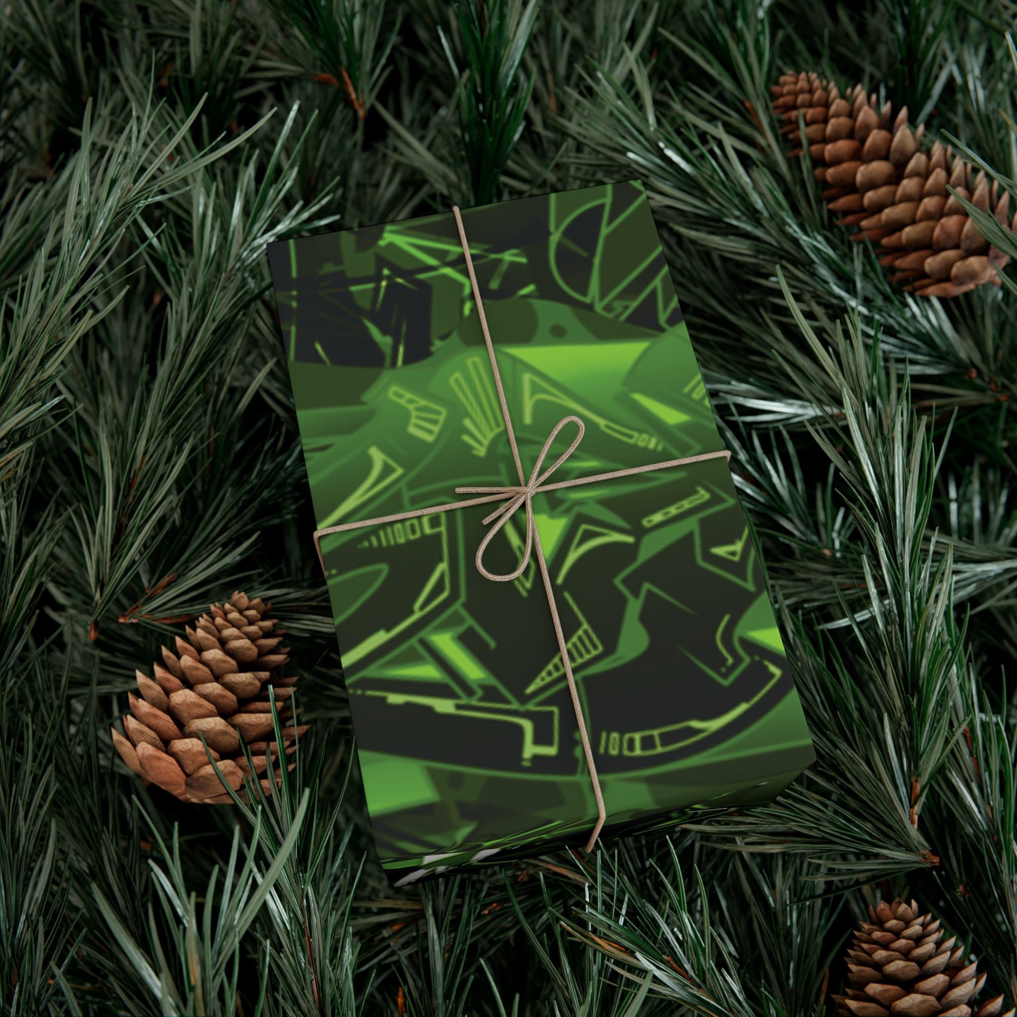 Green gift box with black designs on a bed of pine needles and pine cones