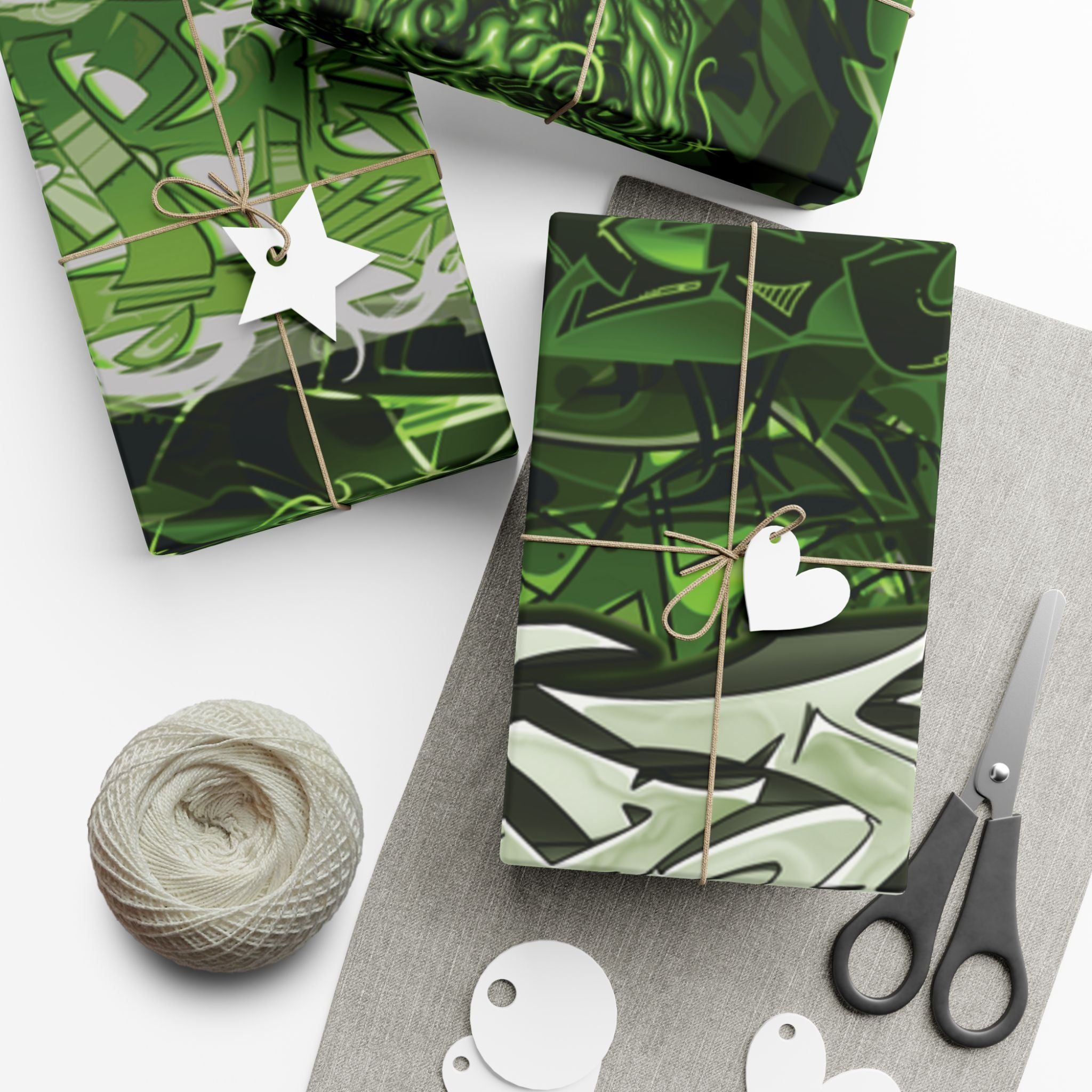 Green patterned gift wrap with decorative elements on a white surface