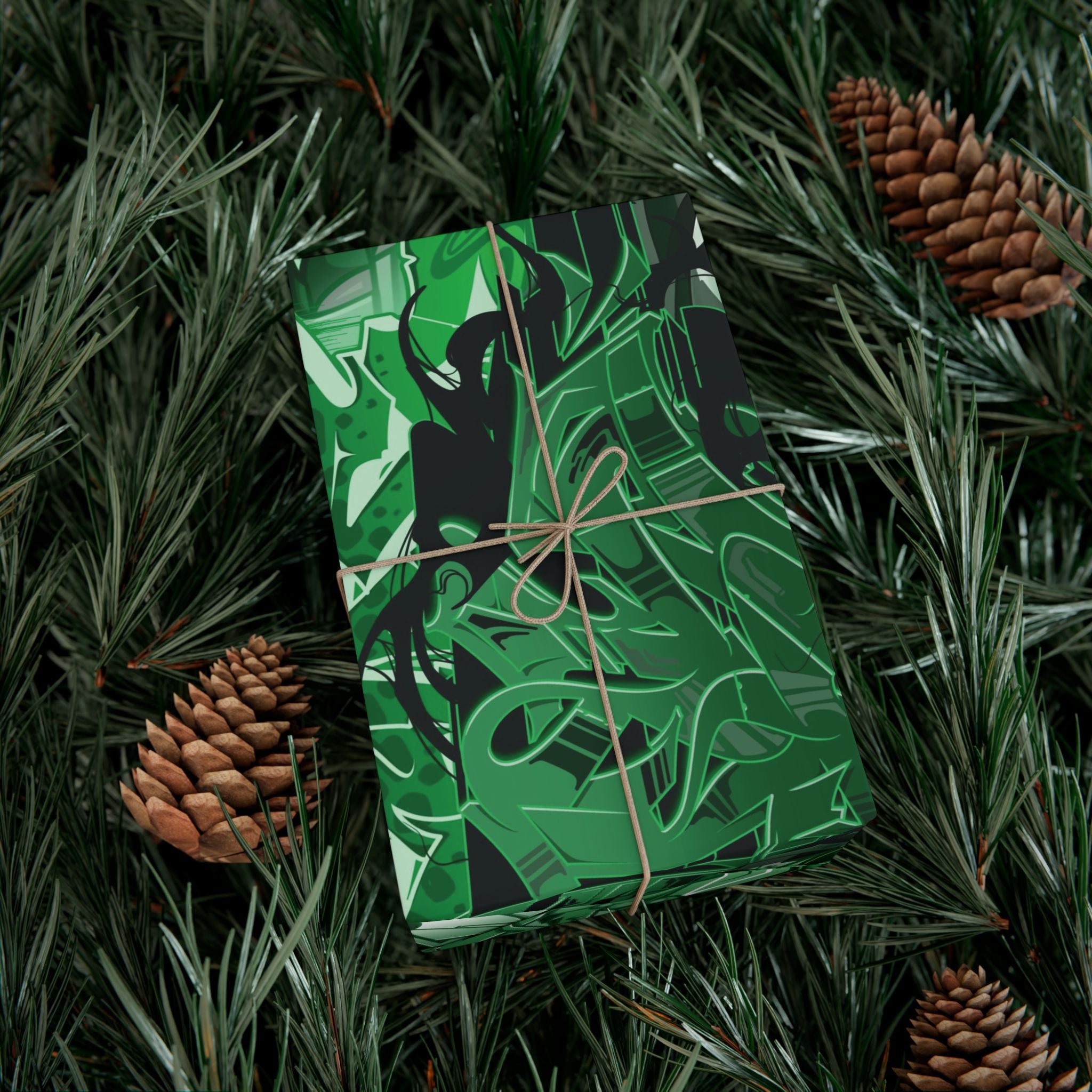 Green and black patterned gift box tied with brown string on a pine branch background