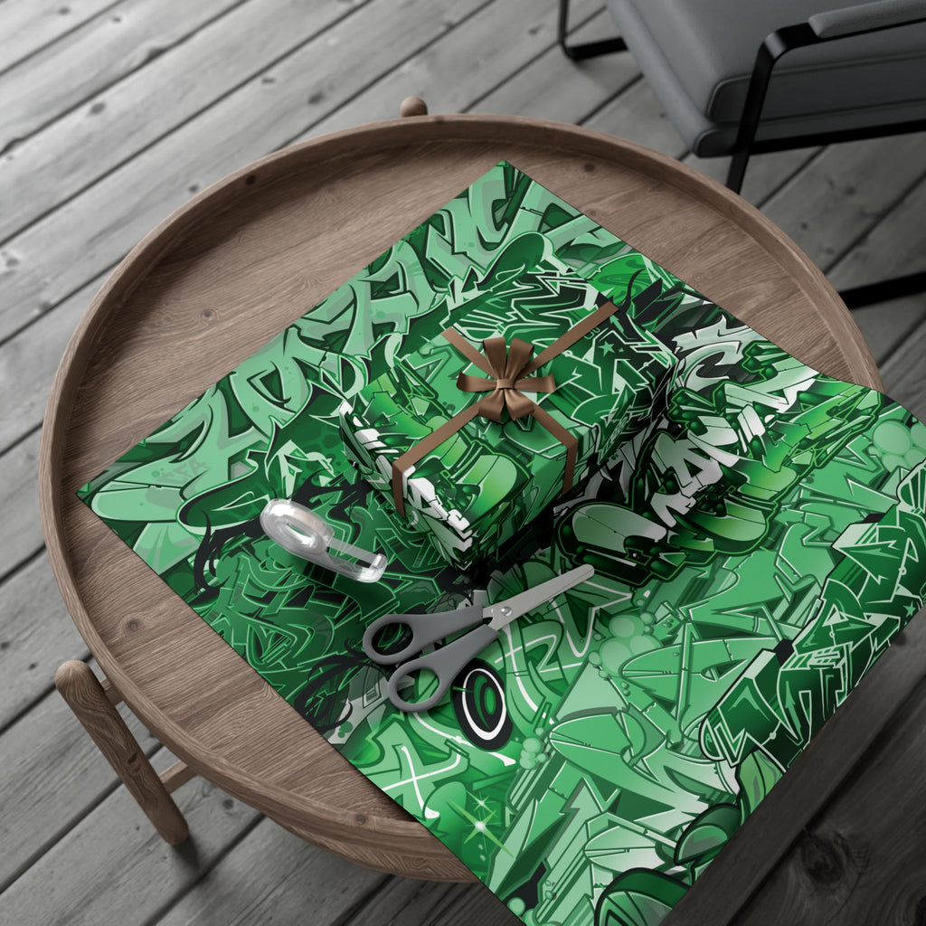 Green patterned gift box with scissors on a wooden surface