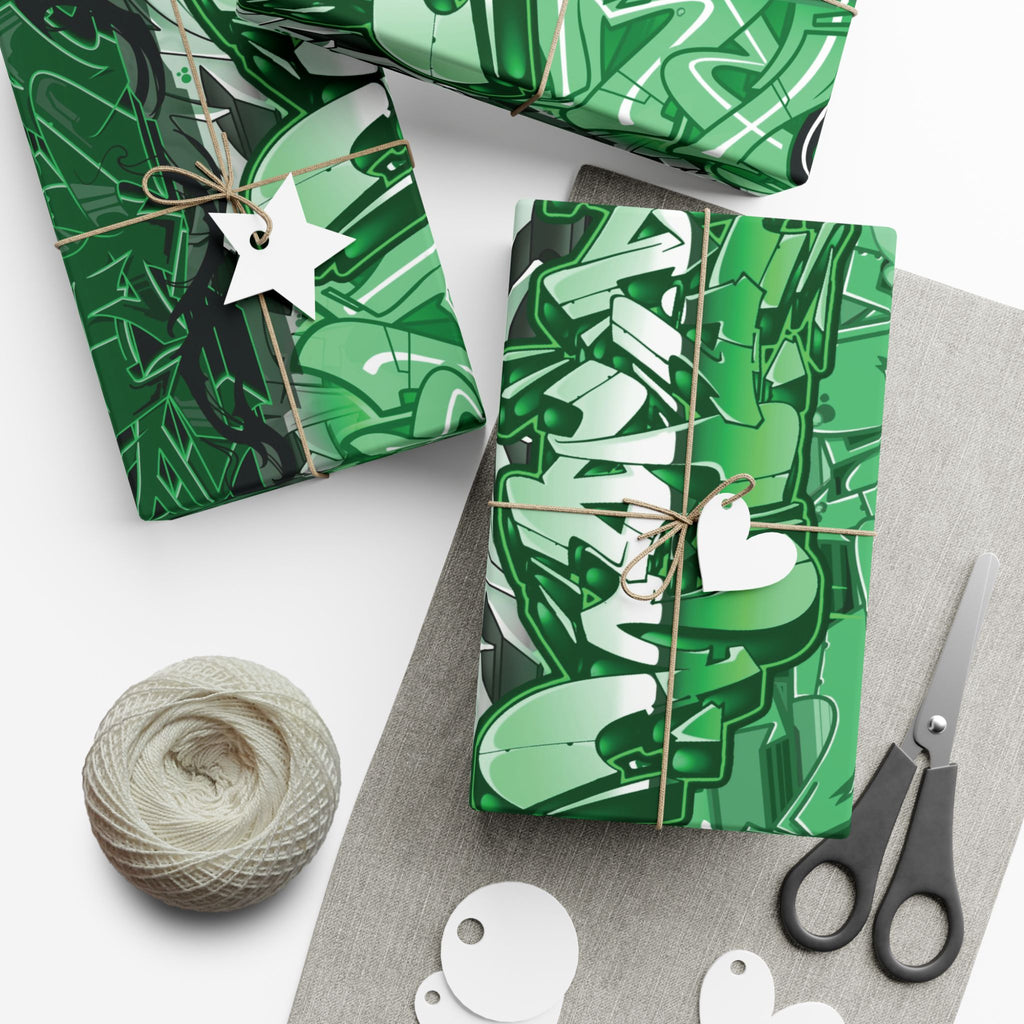 Green patterned gift wrap with scissors and yarn on a white surface