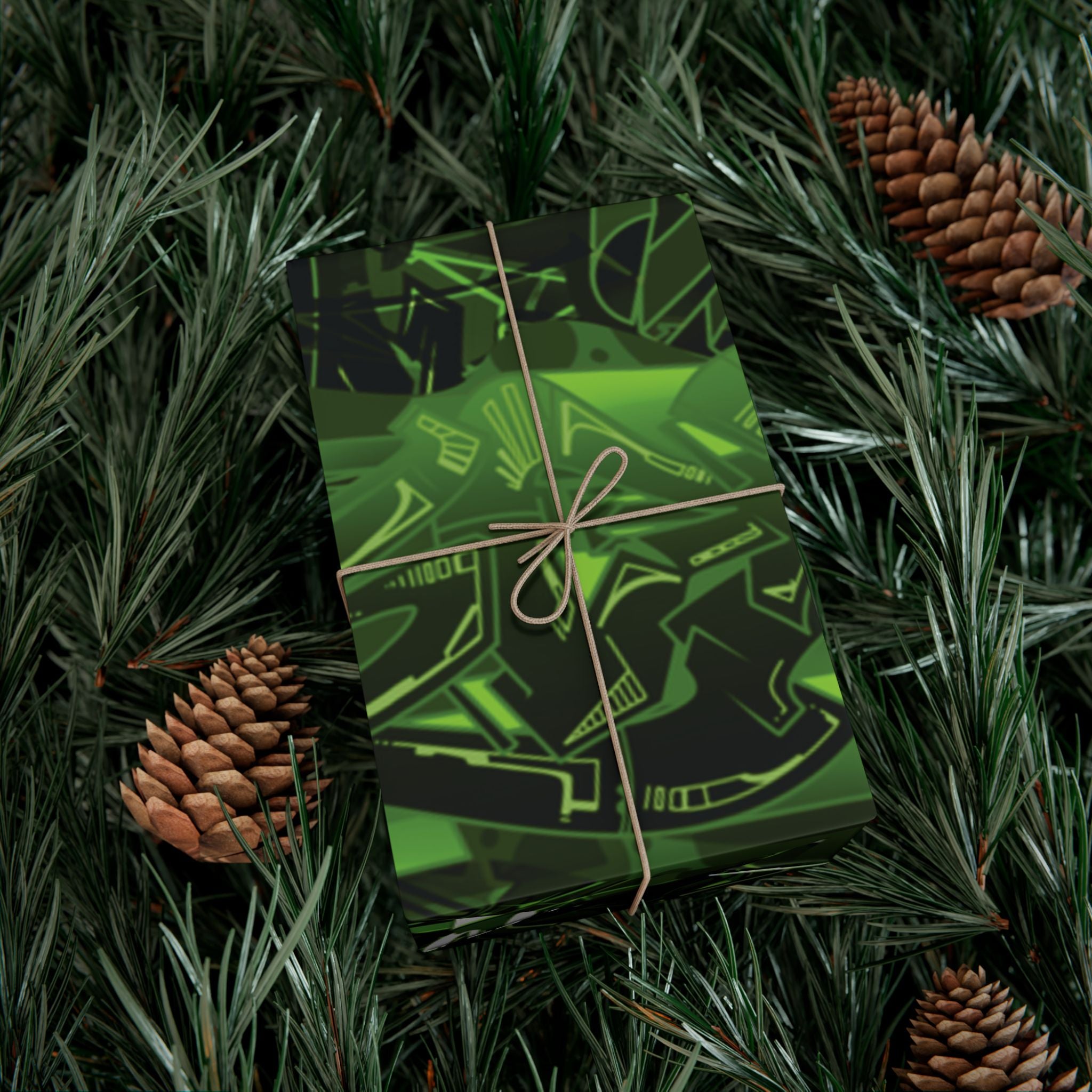 Green gift box with black patterns on a bed of pine needles and pine cones