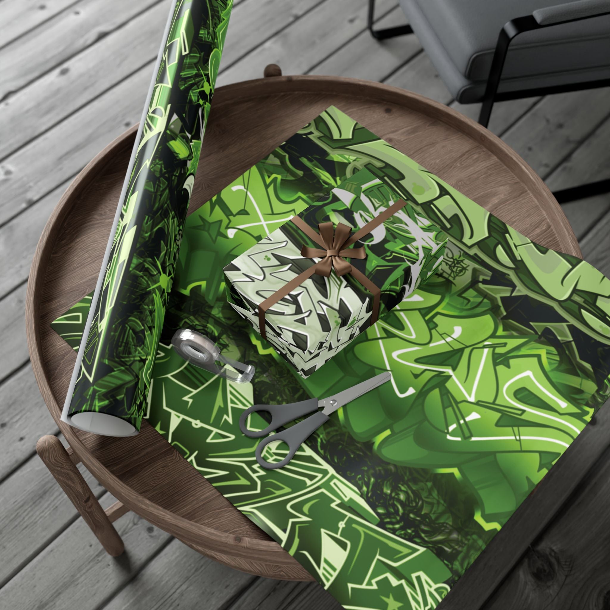 Green patterned paper with a gift and scissors on a wooden table