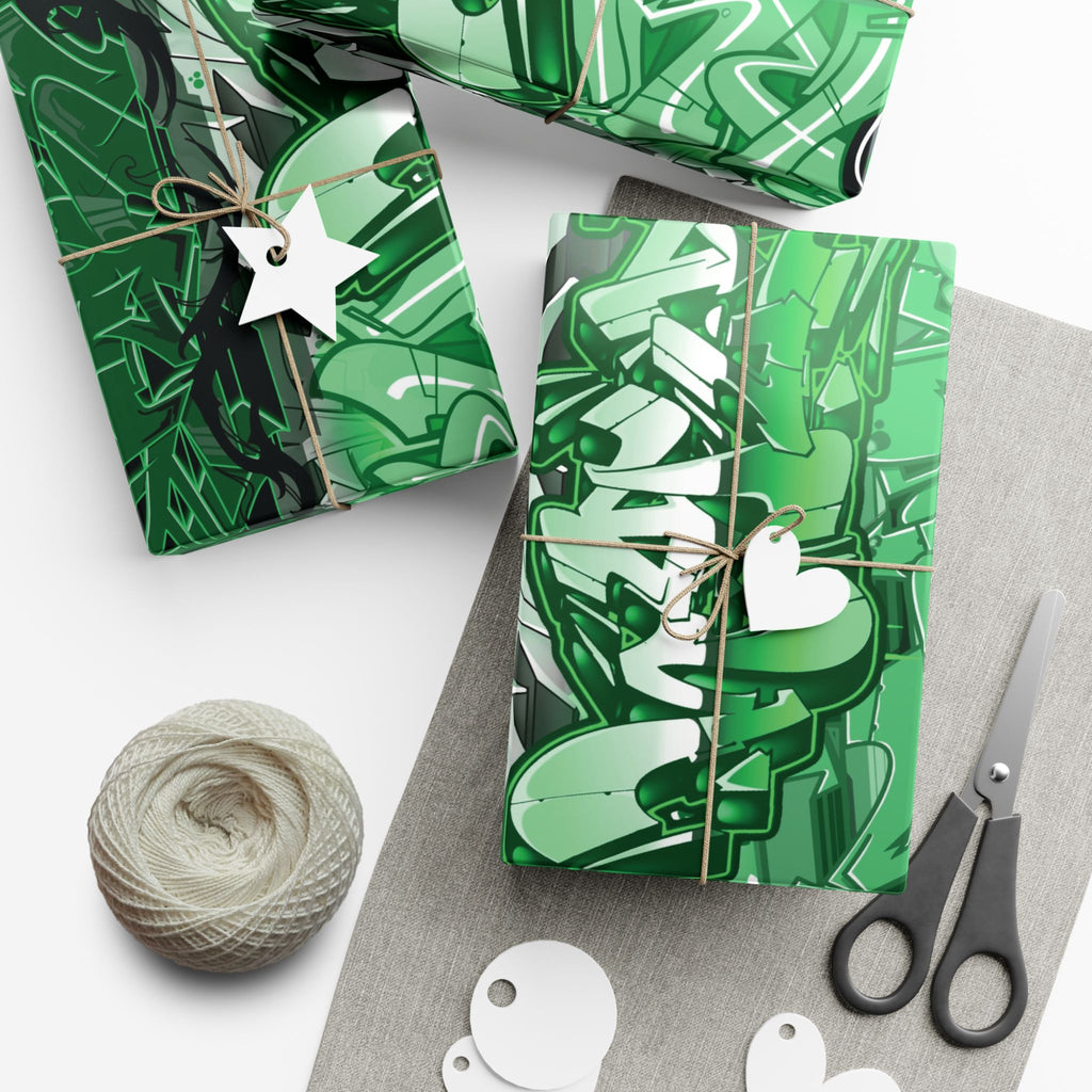 Green patterned gift boxes with string, scissors, and yarn on a white surface
