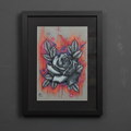 Framed artwork of a rose with abstract background on a dark gray wall