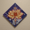 Decorative wall art with a lotus flower design on a beige wall.