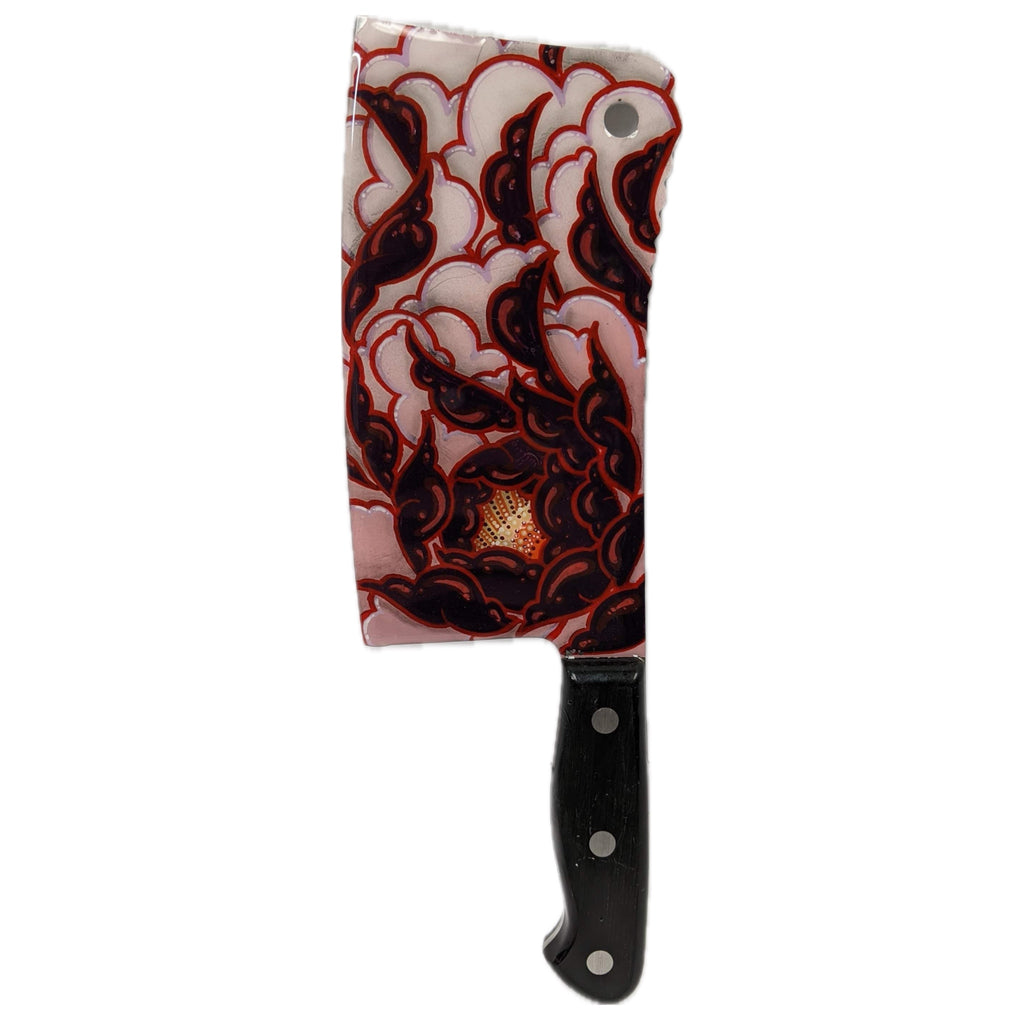 Decorative knife with a red and white patterned handle on a white background