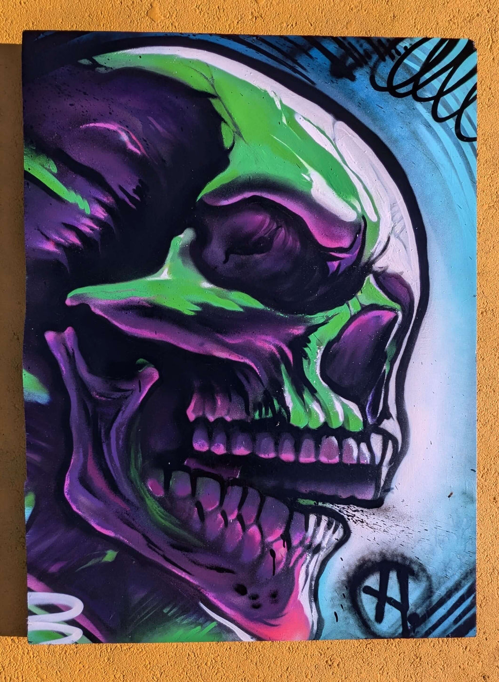 Vibrant graffiti-style skull painting on canvas by Horus, featuring neon purple, green, and black spray paint effects.